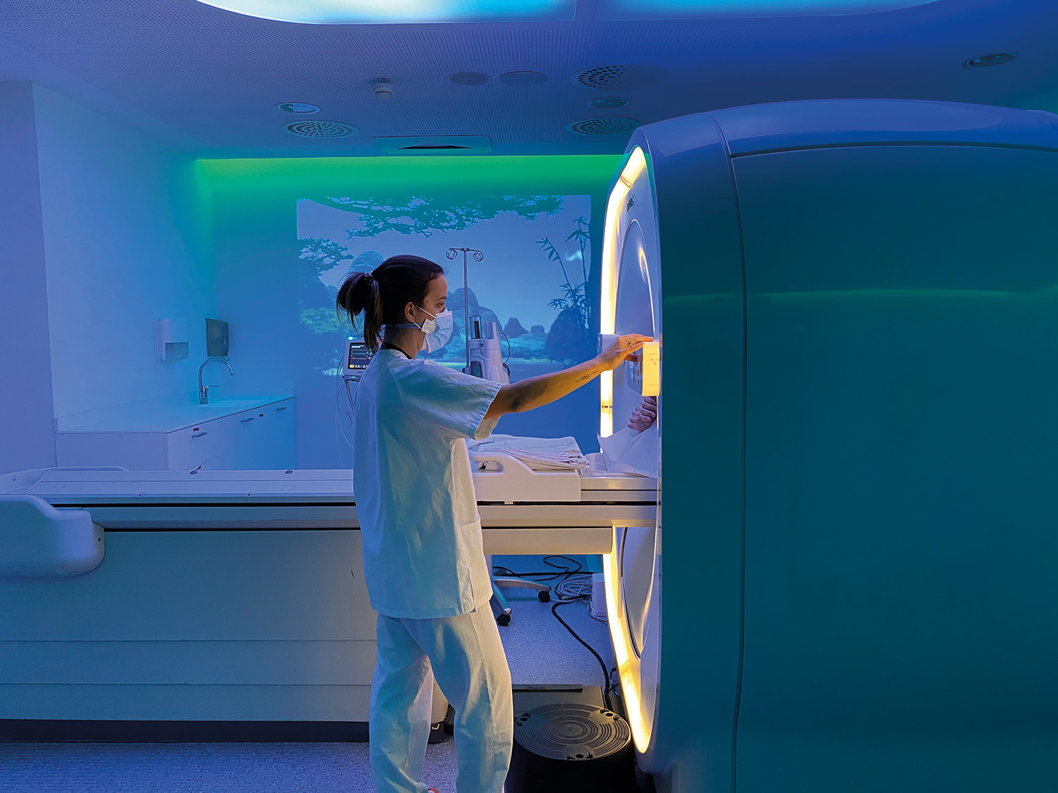 Professional preparing the machine for a CT scan